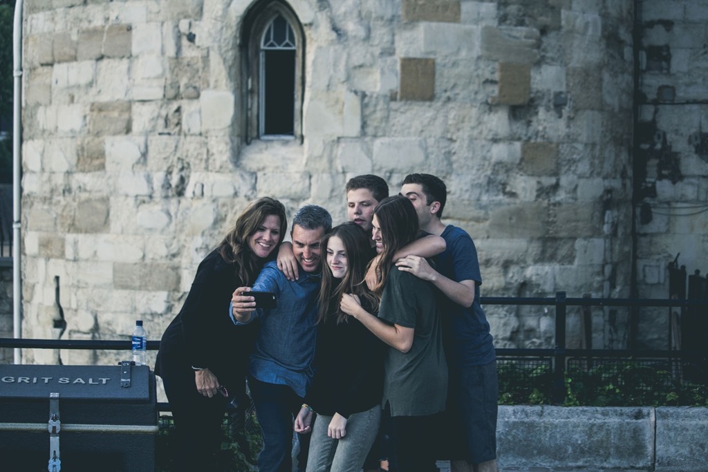 Six people participate in a close group hug.