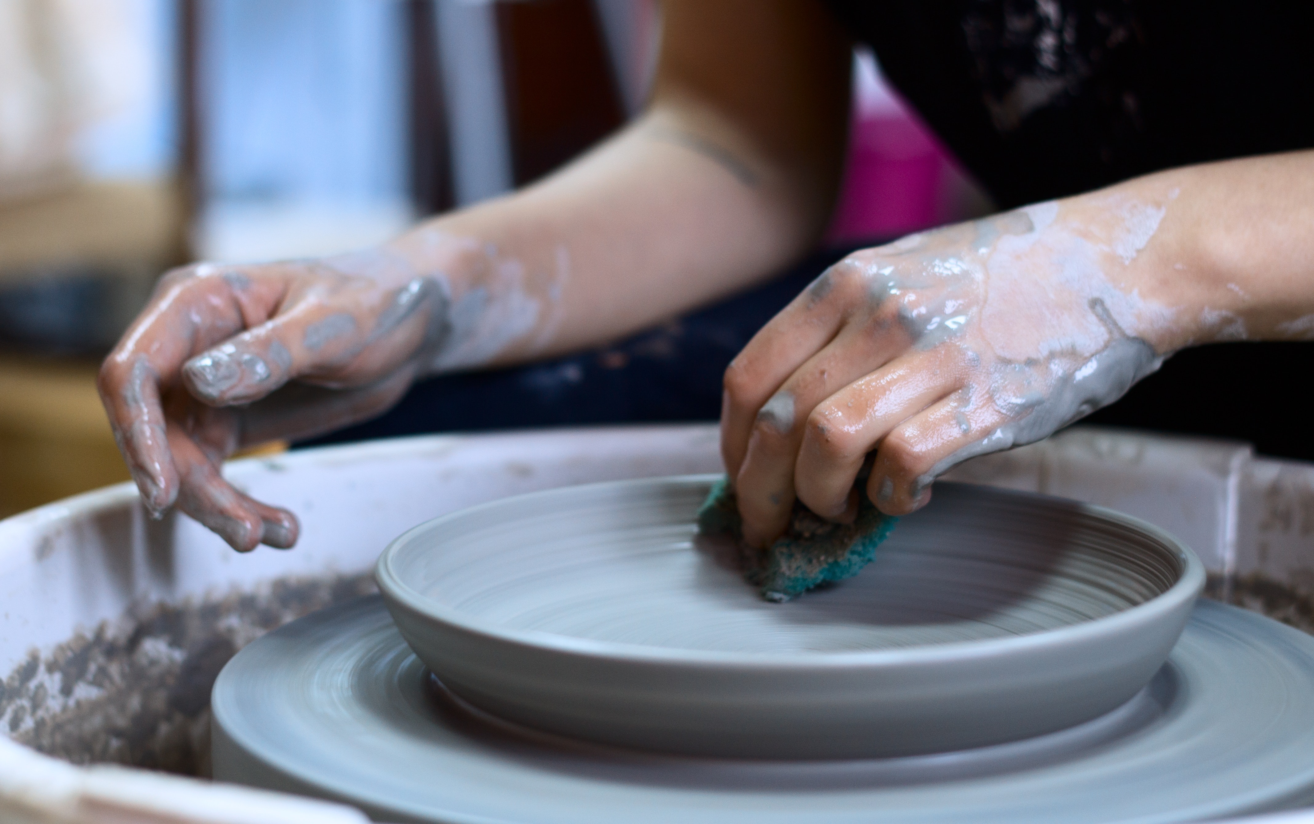 Potter making a clay dish