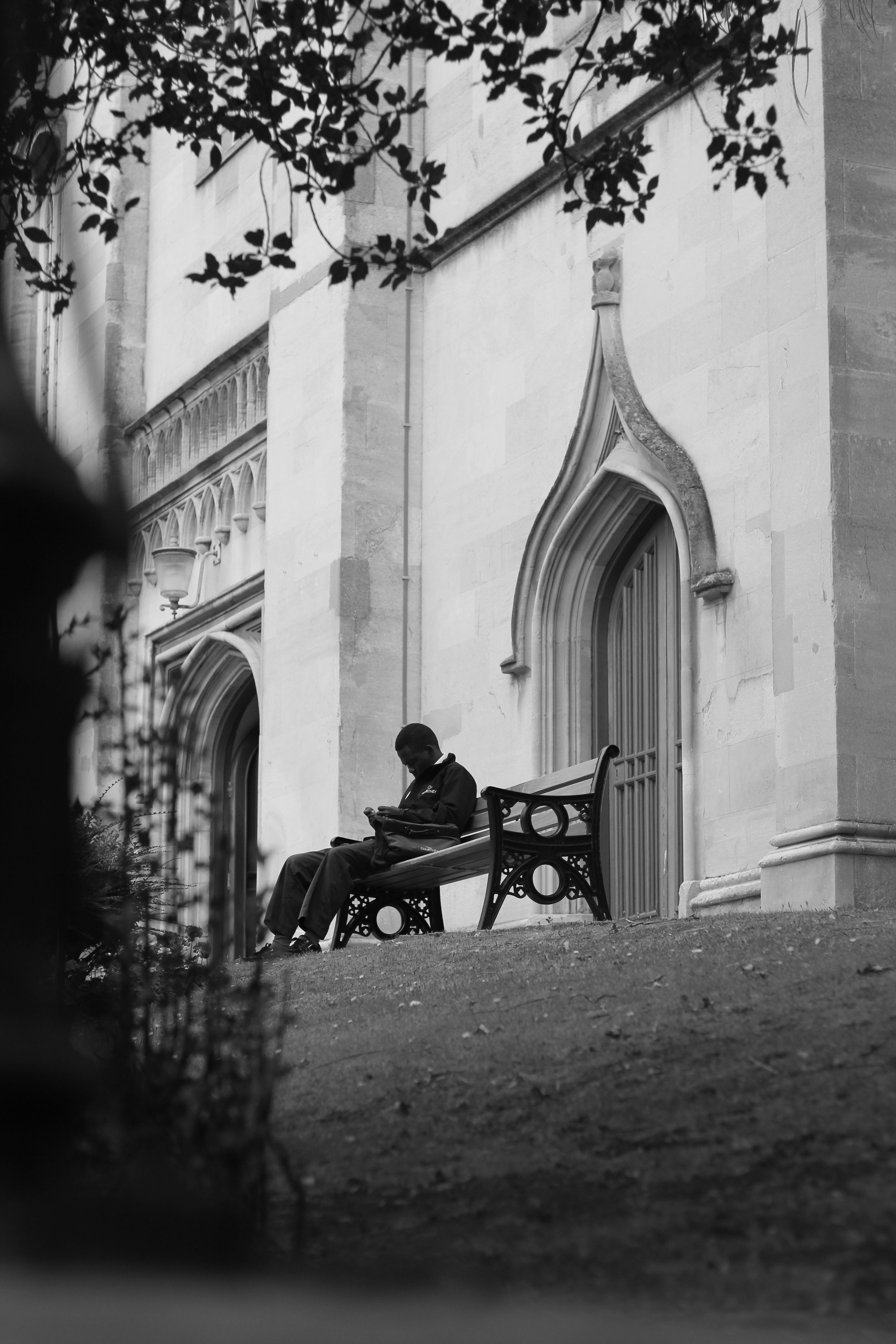 Man sitting on bench by church