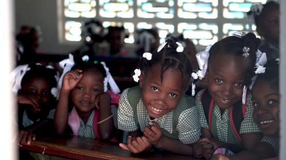 Several Haitian schoolchildren line up for a picture.